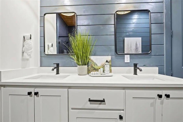full bath with a sink and double vanity