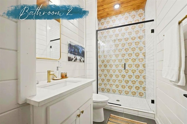 full bathroom featuring a stall shower, vanity, and toilet