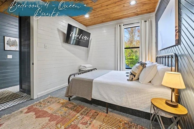 carpeted bedroom with recessed lighting, wooden ceiling, and wooden walls