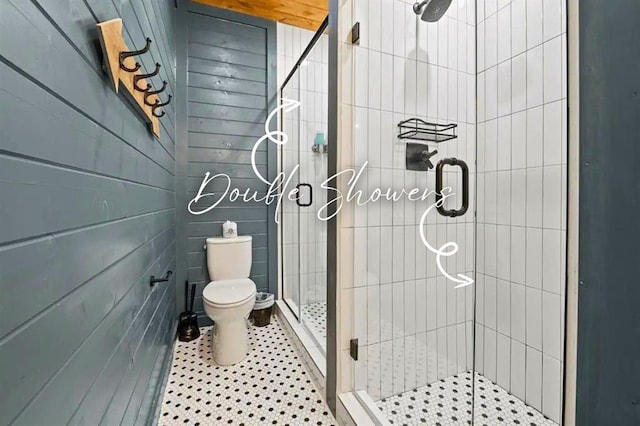full bathroom with tile patterned flooring, a shower stall, and toilet