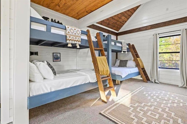 bedroom with lofted ceiling with beams, carpet, and wood ceiling