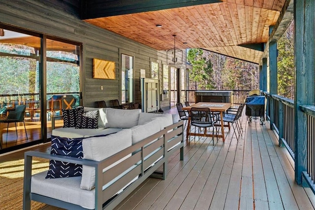wooden terrace featuring an outdoor living space and outdoor dining space