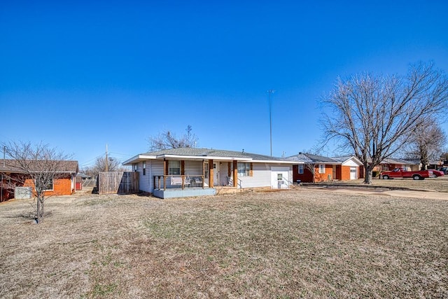 ranch-style home featuring a front yard and covered porch