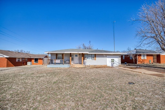 ranch-style home featuring a porch, central AC unit, and a front lawn