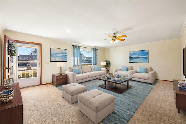 living room featuring ceiling fan, light colored carpet, and ornamental molding