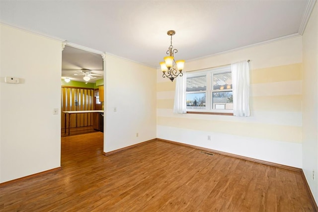 unfurnished room with ornamental molding, a chandelier, and hardwood / wood-style floors