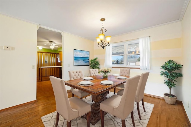 dining room featuring ornamental molding, hardwood / wood-style floors, and a notable chandelier