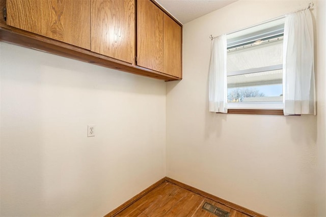 washroom with hardwood / wood-style flooring