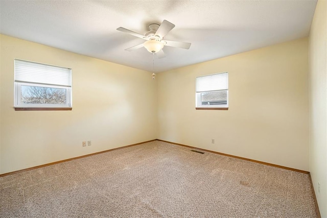 unfurnished room with carpet floors and ceiling fan