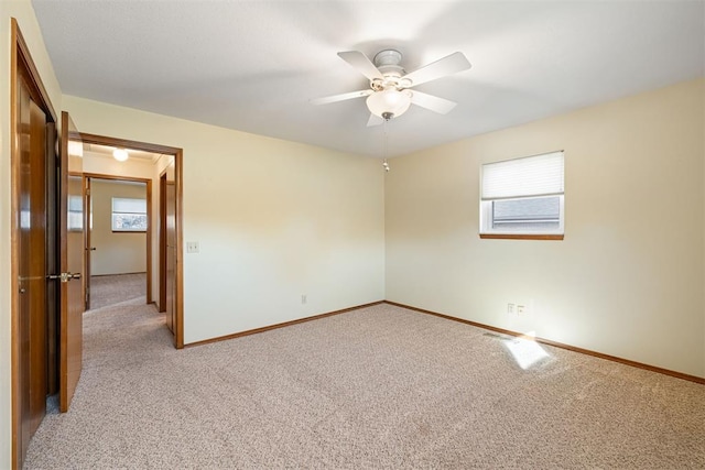 carpeted empty room with ceiling fan