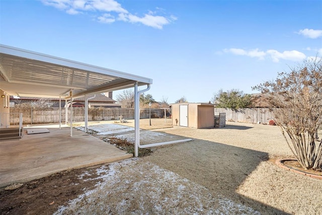 view of yard featuring a patio and a shed