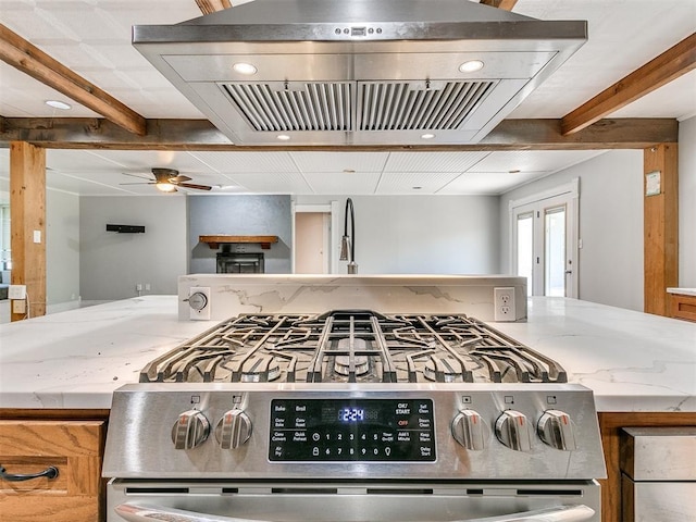 17826 240th St, Washington, OK 73093 - kitchen featuring stainless steel range with gas cooktop, range hood, beamed ceiling, light stone countertops, and a sink