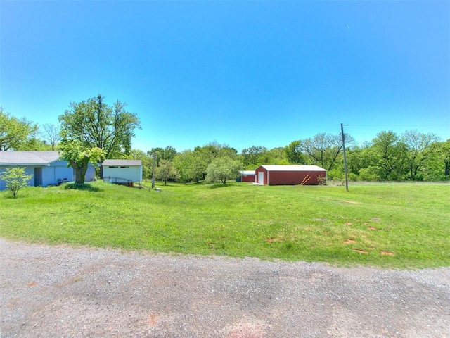 17826 240th St, Washington, OK 73093 - view of green lawn featuring an outbuilding, an outdoor structure, and driveway