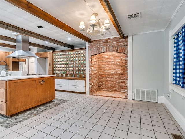 17826 240th St, Washington, OK 73093 - kitchen with island range hood, beam ceiling, brick wall, a chandelier, and light countertops