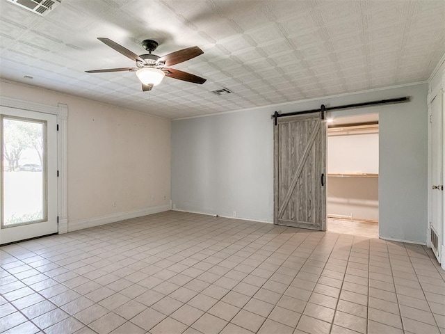 17826 240th St, Washington, OK 73093 - empty room featuring a barn door, ceiling fan, baseboards, crown molding, and light tile patterned floors