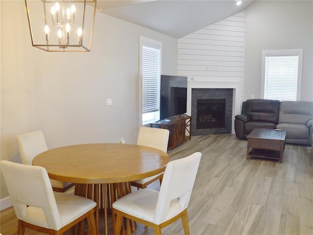 dining area featuring lofted ceiling and light hardwood / wood-style flooring