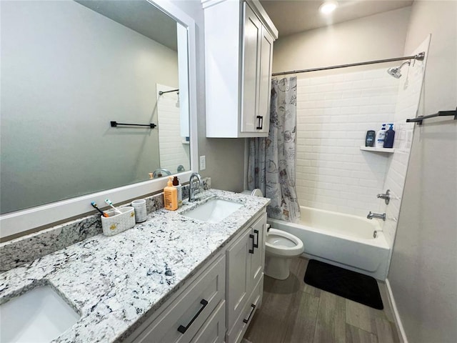 full bathroom featuring hardwood / wood-style flooring, vanity, toilet, and shower / bath combo