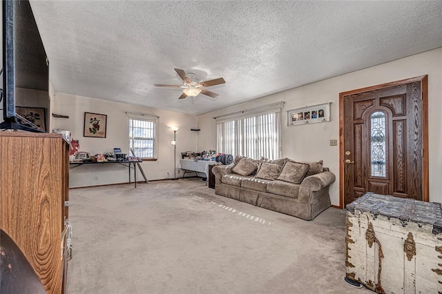 carpeted living room featuring a textured ceiling and ceiling fan