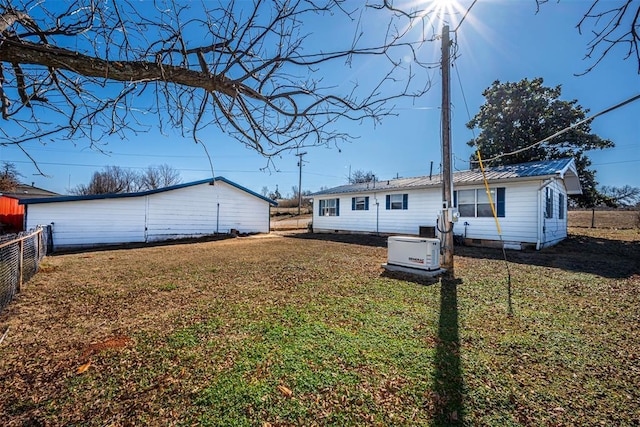 back of property featuring a lawn