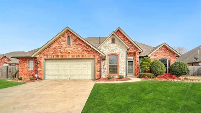 view of front of house with brick siding, concrete driveway, a front yard, fence, and a garage