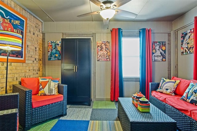 bedroom with a ceiling fan and brick wall