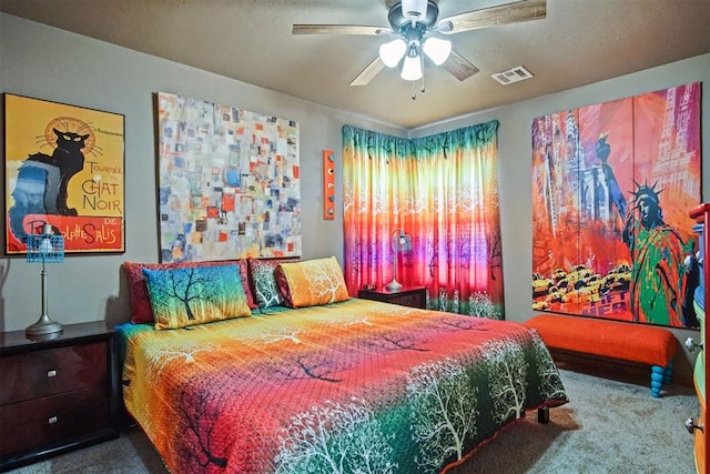 carpeted bedroom with a ceiling fan and visible vents