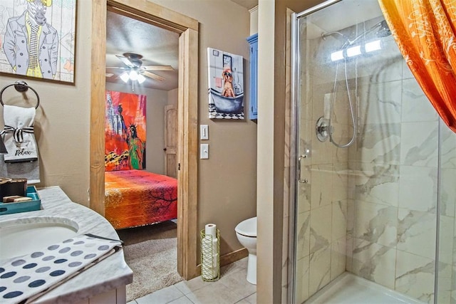 bathroom with toilet, ensuite bathroom, ceiling fan, a shower stall, and tile patterned flooring