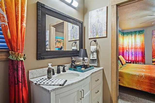 bathroom featuring ensuite bath and vanity