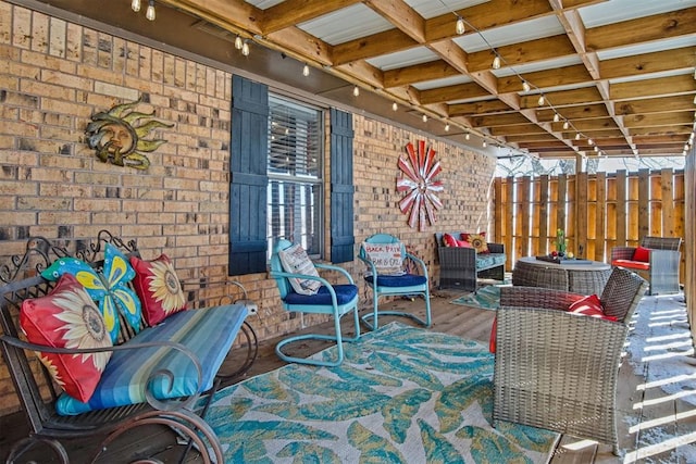 view of patio with a deck and fence