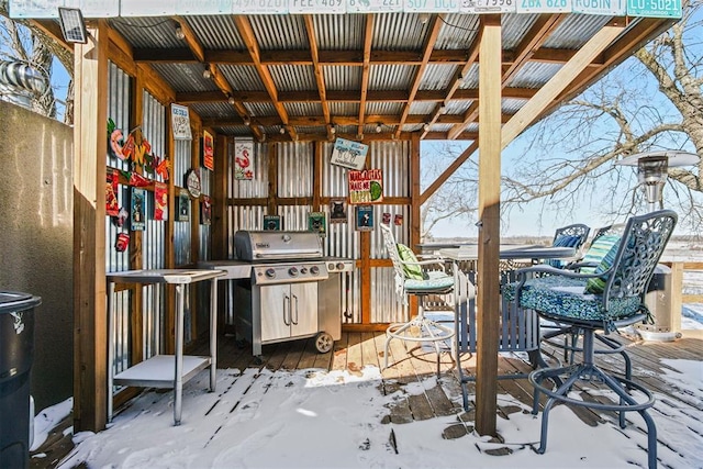 snow covered patio featuring grilling area