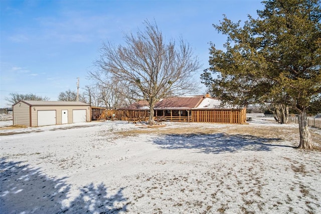 exterior space with an outbuilding and a detached garage