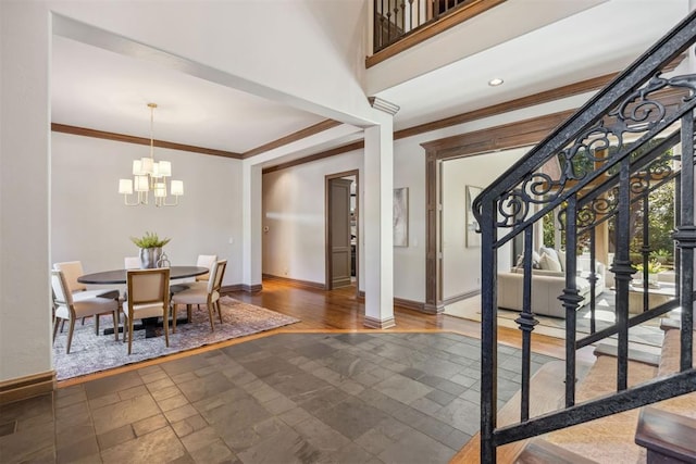 interior space featuring an inviting chandelier, crown molding, and a high ceiling