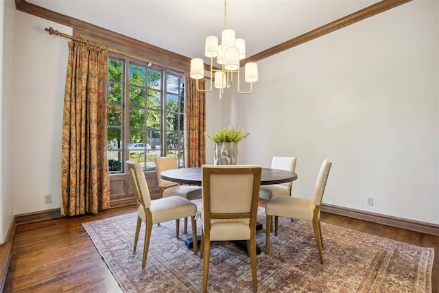 dining room with crown molding, dark hardwood / wood-style flooring, and a notable chandelier