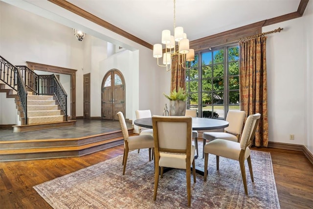 dining space with crown molding, an inviting chandelier, and dark hardwood / wood-style flooring