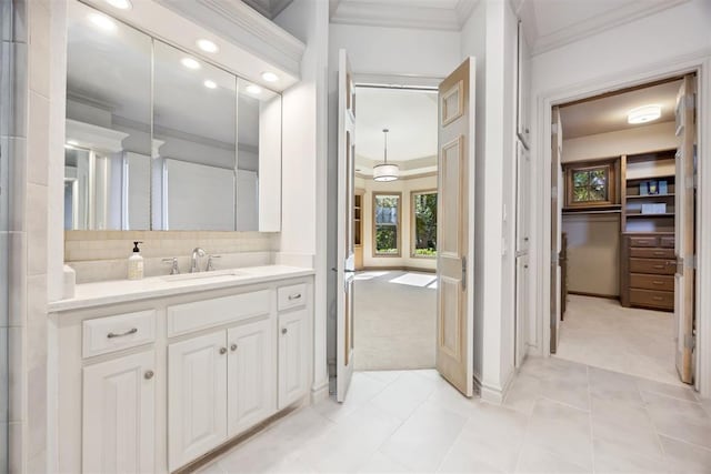 bathroom with tile patterned floors, vanity, ornamental molding, and decorative backsplash