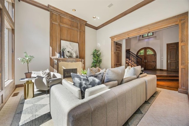 living room with light wood-type flooring and crown molding