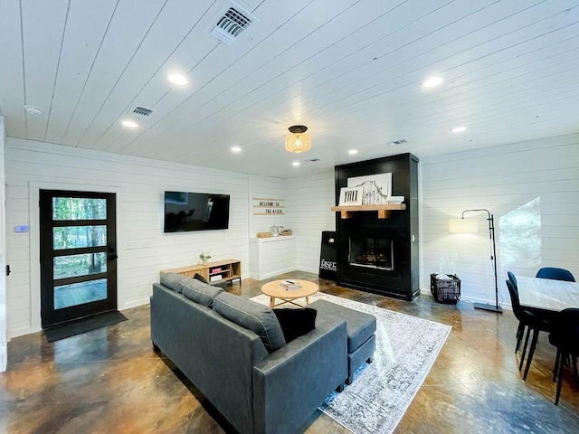 living room featuring a fireplace, visible vents, and recessed lighting