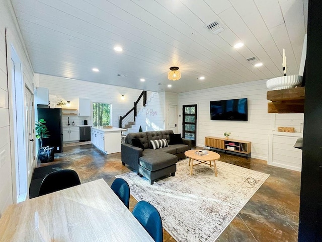 living room with stairway, visible vents, and recessed lighting