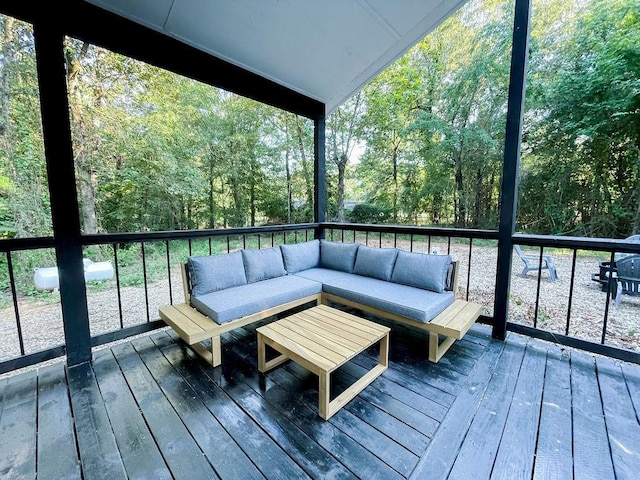 deck featuring a view of trees and an outdoor hangout area