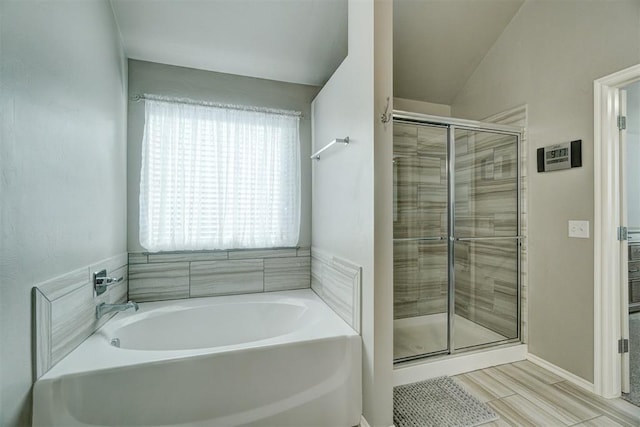 bathroom featuring independent shower and bath