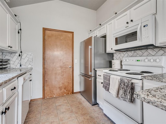 kitchen with white appliances, light tile patterned floors, decorative backsplash, light stone counters, and white cabinetry