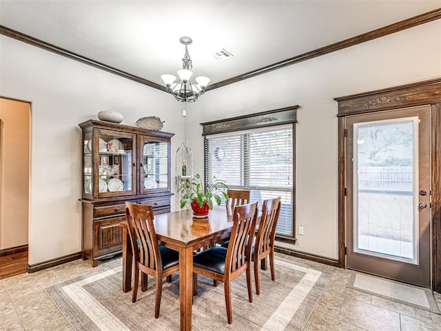 dining space featuring ornamental molding and a chandelier