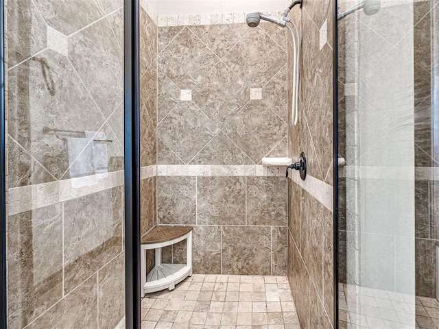 bathroom with a shower with door