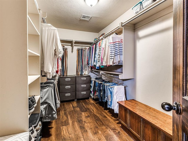 spacious closet with dark hardwood / wood-style floors