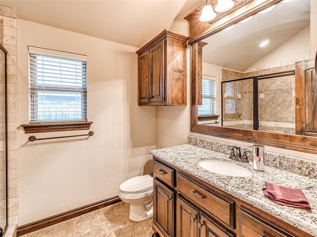 bathroom featuring vanity, vaulted ceiling, a shower with door, and toilet