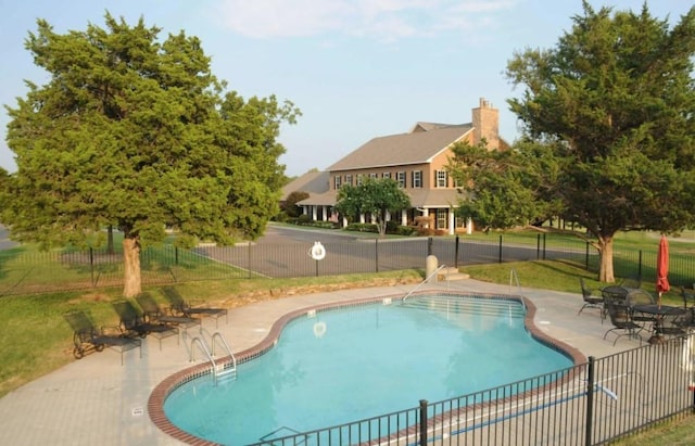 view of swimming pool with a patio