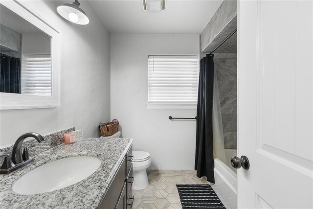 full bathroom with visible vents, toilet, shower / tub combo, vanity, and tile patterned flooring