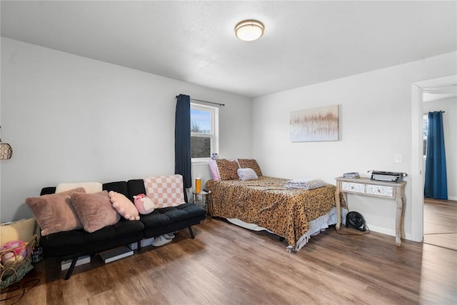 bedroom featuring baseboards and wood finished floors