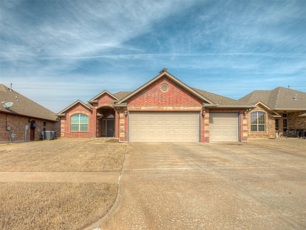 ranch-style house with cooling unit and a garage