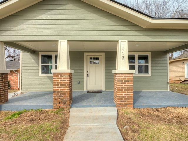 view of front of property with a porch and brick siding